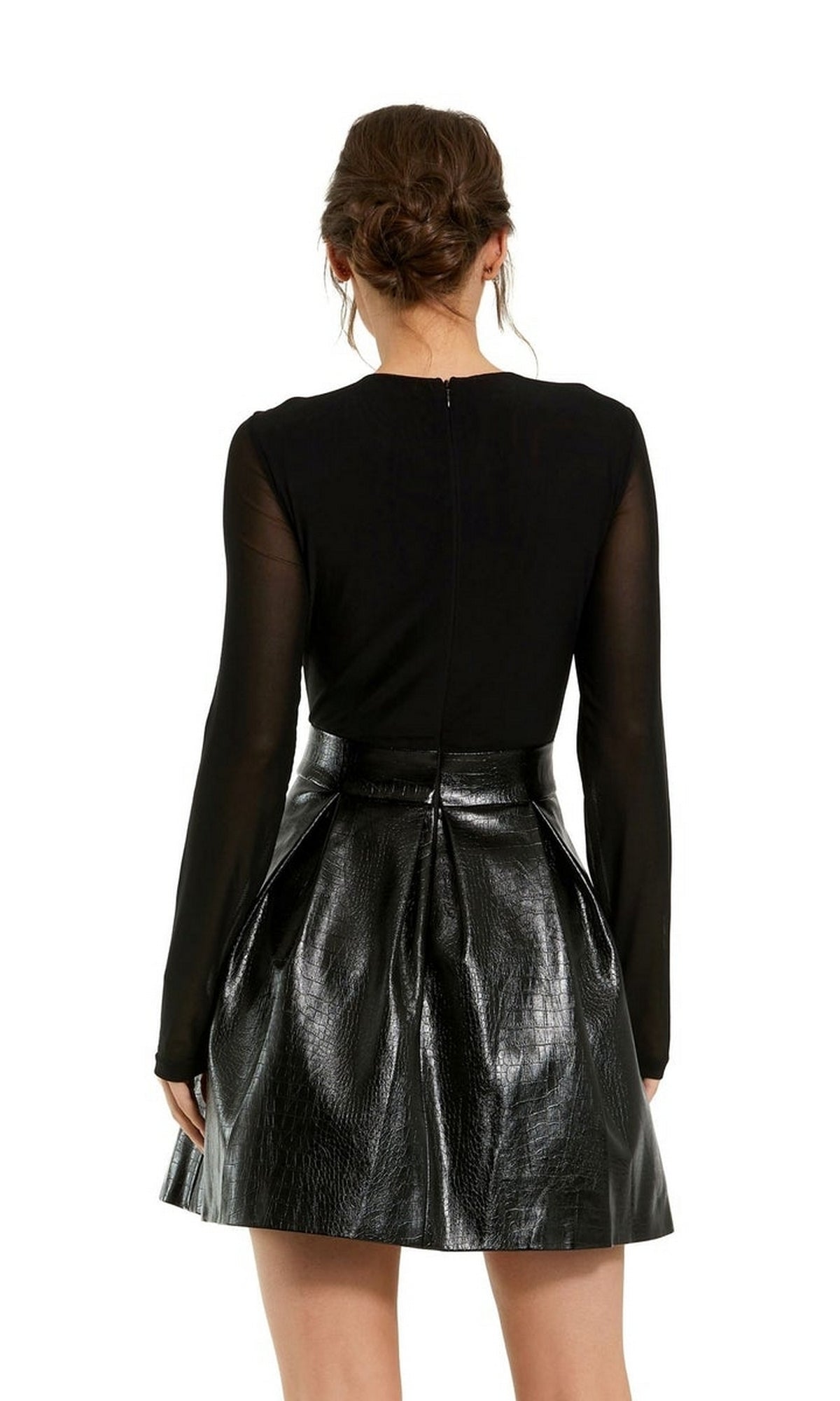 Woman shown from the back in the Sleeved Short Black Dress 81070 by Mac Duggal, featuring a sleek long-sleeve top and a shiny textured A-line leather skirt.